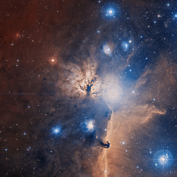 An optical image, from the Digitized Sky Survey, of a large field centered on the Flame Nebula. A comparison with the composite image from Chandra and Spitzer - shown as an overlay - demonstrates how powerful X-ray and infrared images are for studying star forming regions. The central cluster of stars, NGC 2024, is clearly observed in the X-ray and optical images but is not visible in the optical image. (Credit: DSS) An optical image, from the Digitized Sky Survey, of a large field centered on the Flame Nebula. A comparison with the composite image from Chandra and Spitzer - shown as an overlay - demonstrates how powerful X-ray and infrared images are for studying star forming regions. The central cluster of stars, NGC 2024, is clearly observed in the X-ray and optical images but is not visible in the optical image. (Credit: DSS)