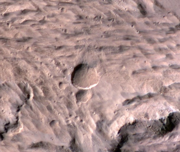 The new Mars crater spans half the length of a football field in this photo from the Mars Reconnaissance Orbiter’s sharpest-sighted camera, the High Resolution Imaging Science Experiment. Image Credit: NASA/JPL-Caltech/University of Arizona The new Mars crater spans half the length of a football field in this photo from the Mars Reconnaissance Orbiter’s sharpest-sighted camera, the High Resolution Imaging Science Experiment. Image Credit: NASA/JPL-Caltech/University of Arizona