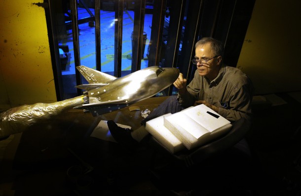 An engineer applies grains of sand to the skin of the model Dream Chaser to aid in the evaluation of airflow around the model. Image Credit: NASA/David C. Bowman An engineer applies grains of sand to the skin of the model Dream Chaser to aid in the evaluation of airflow around the model. Image Credit: NASA/David C. Bowman