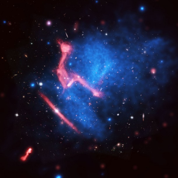 Colliding galaxy clusters MACS J0717+3745, more than 5 billion light-years from Earth. Background is Hubble Space Telescope image; blue is X-ray image from Chandra, and red is VLA radio image. CREDIT: Van Weeren, et al.; Bill Saxton, NRAO/AUI/NSF; NASA. Colliding galaxy clusters MACS J0717+3745, more than 5 billion light-years from Earth. Background is Hubble Space Telescope image; blue is X-ray image from Chandra, and red is VLA radio image. CREDIT: Van Weeren, et al.; Bill Saxton, NRAO/AUI/NSF; NASA.