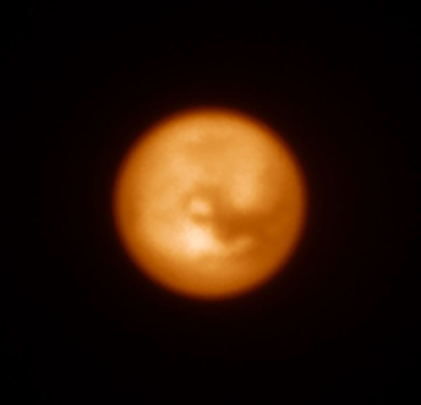 This infrared image of Saturn’s largest moon, Titan, was one of the first produced by the SPHERE instrument soon after it was installed on ESO’s Very Large Telescope in May 2014. This picture shows how effective the adaptive optics system is at revealing fine detail on this tiny disc. Titan was also a target used to test SPHERE’s polarimetric capabilities, which will be crucial to the study of some exoplanets. Credit: ESO/J.-L. Beuzit et al./SPHERE Consortium This infrared image of Saturn’s largest moon, Titan, was one of the first produced by the SPHERE instrument soon after it was installed on ESO’s Very Large Telescope in May 2014. This picture shows how effective the adaptive optics system is at revealing fine detail on this tiny disc. Titan was also a target used to test SPHERE’s polarimetric capabilities, which will be crucial to the study of some exoplanets. Credit: ESO/J.-L. Beuzit et al./SPHERE Consortium