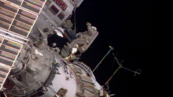 Cosmonaut Oleg Artemyev waves to a video camera after exiting the Pirs docking compartment Thursday morning. Image Credit: NASA TV Cosmonaut Oleg Artemyev waves to a video camera after exiting the Pirs docking compartment Thursday morning. Image Credit: NASA TV