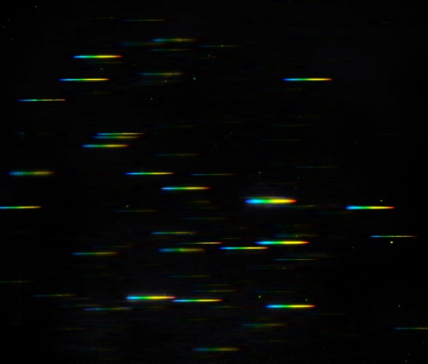 This image represents the data that comes from using the NASA/ESA Hubble Space Telescop's highly-sensitive Wide Field Camera 3 in its grism spectroscopy mode. A grism is a combination of a grating and a prism, and it splits up the light from a galaxy into its constituent colours, producing a spectrum. In this image the continuum of each galaxy is shown as a "rainbow". Credit: NASA & ESA This image represents the data that comes from using the NASA/ESA Hubble Space Telescop's highly-sensitive Wide Field Camera 3 in its grism spectroscopy mode. A grism is a combination of a grating and a prism, and it splits up the light from a galaxy into its constituent colours, producing a spectrum. In this image the continuum of each galaxy is shown as a "rainbow". Credit: NASA & ESA