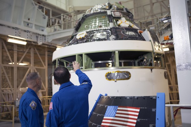 Astronauts Doug Hurley and Rex Walheim examine Orion and a section of the black back shell tiles that will be installed on spacecraft now that the testing of the stacked crew and service module is complete. Image Credit: NASA Astronauts Doug Hurley and Rex Walheim examine Orion and a section of the black back shell tiles that will be installed on spacecraft now that the testing of the stacked crew and service module is complete. Image Credit: NASA