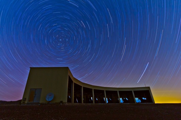 In this time-lapse photo, stars appear to rotate above the Middle Drum facility of the Telescope Array, a $25 million cosmic ray observatory that sprawls across the desert west of Delta, Utah. Physicists from the University of Utah, University of Tokyo and elsewhere report the observatory has detected a “hotspot” in the northern sky emitting a disproportionate number of ultrahigh-energy cosmic rays, which are the most energetic particles in the universe. The discovery of a hotspot is a step in the long quest to discover the source or sources of the most powerful cosmic rays. Photo Credit: Ben Stokes, University of Utah In this time-lapse photo, stars appear to rotate above the Middle Drum facility of the Telescope Array, a $25 million cosmic ray observatory that sprawls across the desert west of Delta, Utah. Physicists from the University of Utah, University of Tokyo and elsewhere report the observatory has detected a “hotspot” in the northern sky emitting a disproportionate number of ultrahigh-energy cosmic rays, which are the most energetic particles in the universe. The discovery of a hotspot is a step in the long quest to discover the source or sources of the most powerful cosmic rays. Photo Credit: Ben Stokes, University of Utah