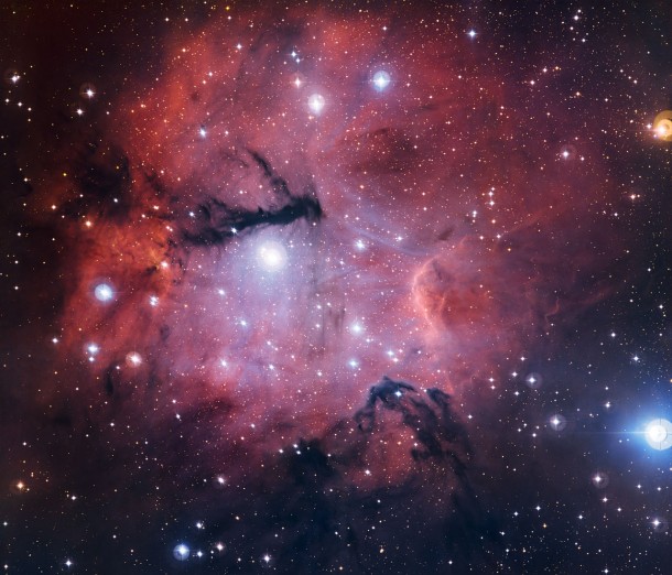 This richly detailed new view from the MPG/ESO 2.2-metre telescope at the La Silla Observatory in Chile shows the star formation region Gum 15. This little-known object is located in the constellation of Vela (The Sails), some 3000 light-years from Earth. The glowing cloud is a stunning example of an HII region. It also has a similarity to a more famous HII region, the Trifid Nebula (Messier 20). Credit: ESO This richly detailed new view from the MPG/ESO 2.2-metre telescope at the La Silla Observatory in Chile shows the star formation region Gum 15. This little-known object is located in the constellation of Vela (The Sails), some 3000 light-years from Earth. The glowing cloud is a stunning example of an HII region. It also has a similarity to a more famous HII region, the Trifid Nebula (Messier 20). Credit: ESO