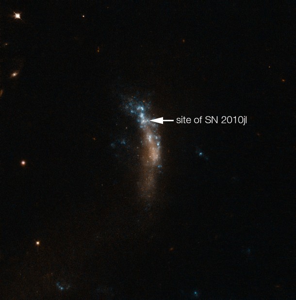 This image from the NASA/ESA Hubble Space Telescope shows the irregular dwarf galaxy UGC 5189A. This star-forming galaxy was the site of the bright supernova SN 2010jl. VLT observations of this supernova have shown that these cosmic dust factories make their grains in a two-stage process, starting soon after the explosion, but continuing long afterwards. This image was taken before the supernova exploded, but the position of the massive progenitor star that exploded is marked. Credit: ESO This image from the NASA/ESA Hubble Space Telescope shows the irregular dwarf galaxy UGC 5189A. This star-forming galaxy was the site of the bright supernova SN 2010jl. VLT observations of this supernova have shown that these cosmic dust factories make their grains in a two-stage process, starting soon after the explosion, but continuing long afterwards. This image was taken before the supernova exploded, but the position of the massive progenitor star that exploded is marked. Credit: ESO