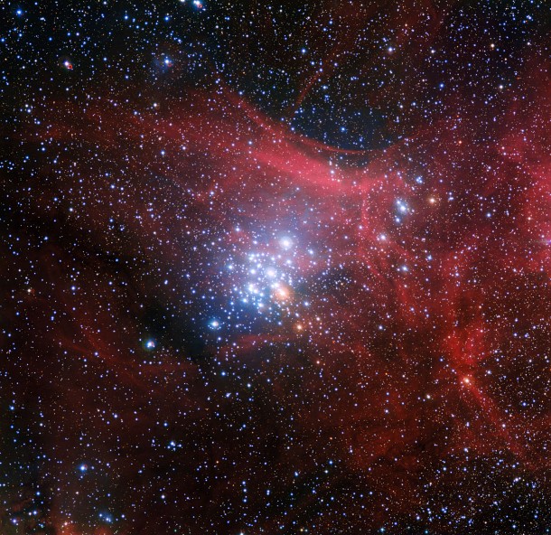 In this image from the Wide Field Imager on the MPG/ESO 2.2-metre telescope at ESO’s La Silla Observatory in Chile young stars huddle together against a backdrop of clouds of glowing gas and lanes of dust. The star cluster, known as NGC 3293, would have been just a cloud of gas and dust itself about ten million years ago, but as stars began to form it became the bright group we see here. Clusters like this are celestial laboratories that allow astronomers to learn more about how stars evolve. Credit: ESO/G. Beccari In this image from the Wide Field Imager on the MPG/ESO 2.2-metre telescope at ESO’s La Silla Observatory in Chile young stars huddle together against a backdrop of clouds of glowing gas and lanes of dust. The star cluster, known as NGC 3293, would have been just a cloud of gas and dust itself about ten million years ago, but as stars began to form it became the bright group we see here. Clusters like this are celestial laboratories that allow astronomers to learn more about how stars evolve. Credit: ESO/G. Beccari