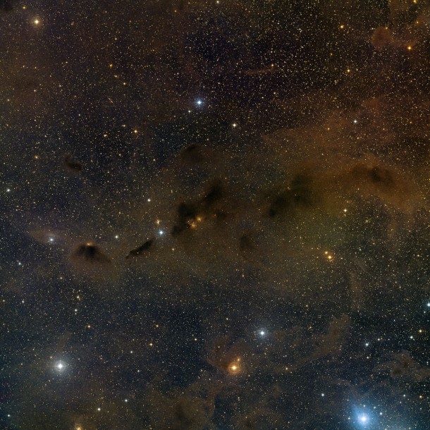 This wide field image shows extensive dust and small clumps of star formation in part of the Taurus star formation region. A faint star at the centre of this picture is the young binary star system HK Tauri. ALMA observations of this system have provided the clearest picture ever of protoplanetary discs in a double star. The new result demonstrates one possible way to explain why so many exoplanets — unlike the planets in the Solar System — came to have strange, eccentric or inclined orbits. This picture was created from images from the Digitized Sky Survey 2. Credit: ESO/Digitized Sky Survey 2. Acknowledgement: Davide De Martin This wide field image shows extensive dust and small clumps of star formation in part of the Taurus star formation region. A faint star at the centre of this picture is the young binary star system HK Tauri. ALMA observations of this system have provided the clearest picture ever of protoplanetary discs in a double star. The new result demonstrates one possible way to explain why so many exoplanets — unlike the planets in the Solar System — came to have strange, eccentric or inclined orbits. This picture was created from images from the Digitized Sky Survey 2. Credit: ESO/Digitized Sky Survey 2. Acknowledgement: Davide De Martin