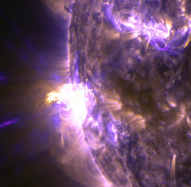 This close-up of a moderate flare on Aug. 24, 2014, shows light in the 131 and 171 Angstrom wavelengths. The former wavelength, usually colorized in teal, highlights the extremely hot material of a flare. The latter, usually colorized in gold, highlights magnet loops in the sun's atmosphere. Image Credit: NASA/SDO This close-up of a moderate flare on Aug. 24, 2014, shows light in the 131 and 171 Angstrom wavelengths. The former wavelength, usually colorized in teal, highlights the extremely hot material of a flare. The latter, usually colorized in gold, highlights magnet loops in the sun's atmosphere. Image Credit: NASA/SDO