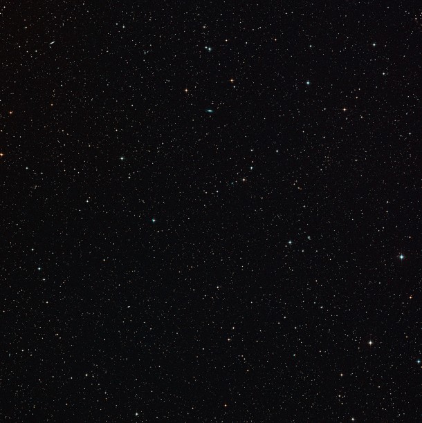This wide-field view of the sky around the gravitationally lensed galaxy merger H-ATLAS J142935.3-002836 was created from images in the Digitized Sky Survey 2. This comparatively empty patch of sky features few stars and many faint galaxies — including one that has by chance acted like a magnifying glass and focussed light from a much dimmer and remote star-forming galaxy merger. Credit: ESO/Digitized Sky Survey 2. Acknowledgement: Davide De Martin This wide-field view of the sky around the gravitationally lensed galaxy merger H-ATLAS J142935.3-002836 was created from images in the Digitized Sky Survey 2. This comparatively empty patch of sky features few stars and many faint galaxies — including one that has by chance acted like a magnifying glass and focussed light from a much dimmer and remote star-forming galaxy merger. Credit: ESO/Digitized Sky Survey 2. Acknowledgement: Davide De Martin