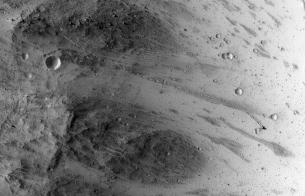 The track left by an oblong boulder as it tumbled down a slope on Mars runs from upper left to right center of this image. The boulder came to rest in an upright attitude at the downhill end of the track. The HiRISE camera on NASA's Mars Reconnaissance Orbiter recorded this view on July 3, 2014. Image Credit: NASA/JPL-Caltech/Univ. of Arizona The track left by an oblong boulder as it tumbled down a slope on Mars runs from upper left to right center of this image. The boulder came to rest in an upright attitude at the downhill end of the track. The HiRISE camera on NASA's Mars Reconnaissance Orbiter recorded this view on July 3, 2014. Image Credit: NASA/JPL-Caltech/Univ. of Arizona