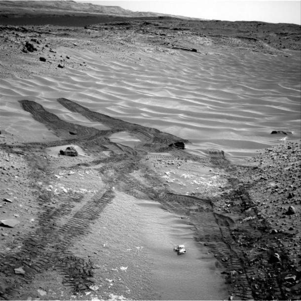 This image from NASA's Curiosity Mars rover looks down the ramp at the northeastern end of "Hidden Valley" and across the sandy-floored valley to lower slopes of Mount Sharp on the horizon. The rover's Navigation Camera captured this southward view on Aug. 12, 2014, after exiting the valley. Image Credit: NASA/JPL-Caltech This image from NASA's Curiosity Mars rover looks down the ramp at the northeastern end of "Hidden Valley" and across the sandy-floored valley to lower slopes of Mount Sharp on the horizon. The rover's Navigation Camera captured this southward view on Aug. 12, 2014, after exiting the valley. Image Credit: NASA/JPL-Caltech