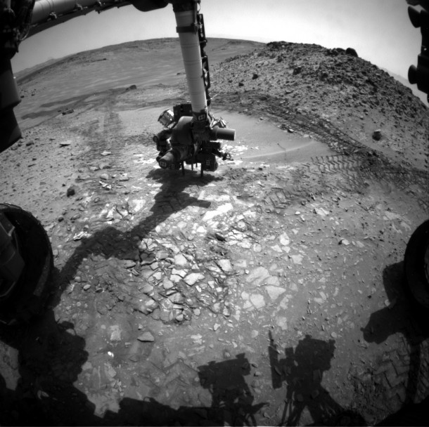This image from the front Hazcam on NASA's Curiosity Mars rover shows the rover's drill in place during a test of whether the rock beneath it, "Bonanza King," would be an acceptable target for drilling to collect a sample. Subsequent analysis showed the rock budged during the Aug. 19, 2014, test. Image Credit: NASA/JPL-Caltech This image from the front Hazcam on NASA's Curiosity Mars rover shows the rover's drill in place during a test of whether the rock beneath it, "Bonanza King," would be an acceptable target for drilling to collect a sample. Subsequent analysis showed the rock budged during the Aug. 19, 2014, test. Image Credit: NASA/JPL-Caltech