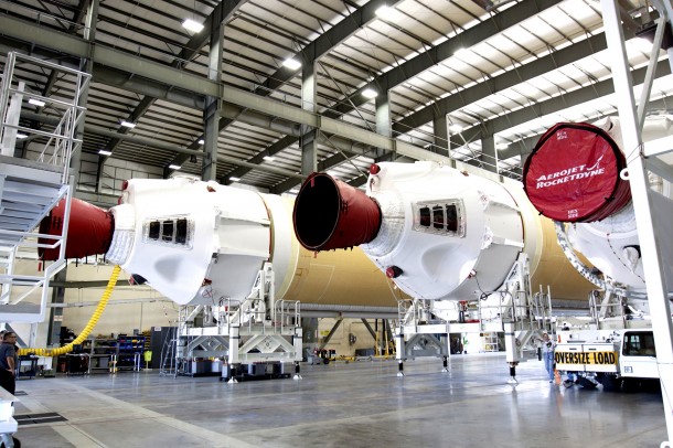 A transporter for oversize loads delivers the port, or left, booster for the United Launch Alliance Delta IV Heavy for Exploration Flight Test-1 into the Horizontal Integration Facility, or HIF, on May 7. The port booster joins the other two boosters of the Delta IV Heavy already in the HIF. Image Credit: NASA/Kim Shiflett A transporter for oversize loads delivers the port, or left, booster for the United Launch Alliance Delta IV Heavy for Exploration Flight Test-1 into the Horizontal Integration Facility, or HIF, on May 7. The port booster joins the other two boosters of the Delta IV Heavy already in the HIF. Image Credit: NASA/Kim Shiflett