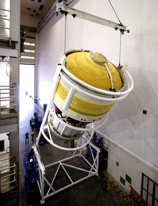 Inside the Delta Operations Center near Space Launch Complex 37 on Cape Canaveral Air Force Station, the second stage for the United Launch Alliance Delta IV Heavy for Exploration Flight Test-1 is lifted high by crane for the move to a test cell. Image Credit: NASA/Frankie Martin Inside the Delta Operations Center near Space Launch Complex 37 on Cape Canaveral Air Force Station, the second stage for the United Launch Alliance Delta IV Heavy for Exploration Flight Test-1 is lifted high by crane for the move to a test cell. Image Credit: NASA/Frankie Martin