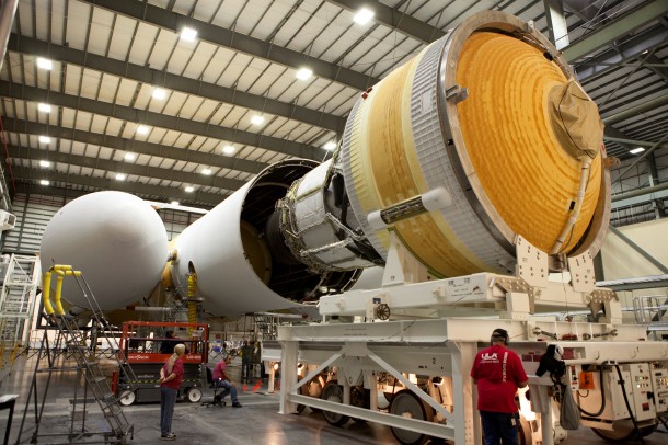 Inside the Horizontal Integration Facility at Space Launch Complex 37 at Cape Canaveral Air Force Station, United Launch Alliance technicians prepare the second stage of a Delta IV Heavy rocket for mating to the central core booster of the three booster stages for the unpiloted Exploration Flight Test-1. Image Credit: NASA/Daniel Casper Inside the Horizontal Integration Facility at Space Launch Complex 37 at Cape Canaveral Air Force Station, United Launch Alliance technicians prepare the second stage of a Delta IV Heavy rocket for mating to the central core booster of the three booster stages for the unpiloted Exploration Flight Test-1. Image Credit: NASA/Daniel Casper