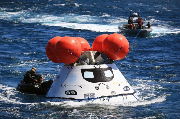 The Orion boilerplate test vehicle floated in the Pacific Ocean, near the USS Anchorage on Sept. 17, during the third day of Underway Recovery Test 3. U.S. Navy divers in a Zodiac boat, at left, and other team members in a rigid hull inflatable boat prepared the test vehicle for return to the ship. Image Credit: NASA/Kim Shiflett The Orion boilerplate test vehicle floated in the Pacific Ocean, near the USS Anchorage on Sept. 17, during the third day of Underway Recovery Test 3. U.S. Navy divers in a Zodiac boat, at left, and other team members in a rigid hull inflatable boat prepared the test vehicle for return to the ship. Image Credit: NASA/Kim Shiflett