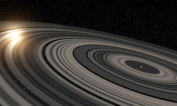 Artist’s conception of the extrasolar ring system circling the young giant planet or brown dwarf J1407b. The rings are shown eclipsing the young sun-like star J1407, as they would have appeared in early 2007. Credit: Ron Miller Artist’s conception of the extrasolar ring system circling the young giant planet or brown dwarf J1407b. The rings are shown eclipsing the young sun-like star J1407, as they would have appeared in early 2007. Credit: Ron Miller