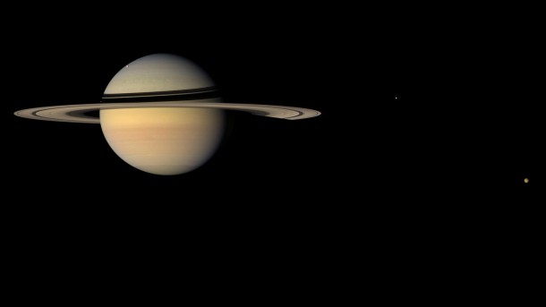 Researchers have determined the location of the Saturn system's center of mass to within just a couple of miles (or kilometers), a factor of 50 improvement over previous knowledge. Image credit: NASA/JPL/Space Science Institute Researchers have determined the location of the Saturn system's center of mass to within just a couple of miles (or kilometers), a factor of 50 improvement over previous knowledge. Image credit: NASA/JPL/Space Science Institute