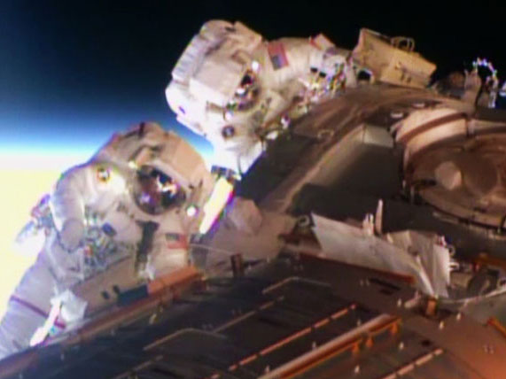 Spacewalkers Barry Wilmore and Terry Virts worked to set up 340 feet of cable on Pressurized Mating Adapter-2 readying it for an International Docking Adapter to accommodate future commercial crew vehicles. Credit: NASA TV Spacewalkers Barry Wilmore and Terry Virts worked to set up 340 feet of cable on Pressurized Mating Adapter-2 readying it for an International Docking Adapter to accommodate future commercial crew vehicles. Credit: NASA TV