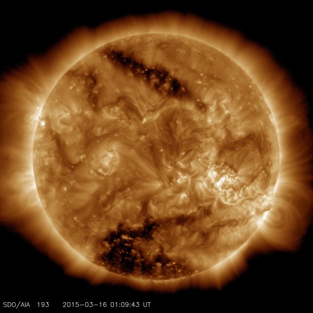 This image from NASA’s Solar Dynamics Observatory on March 16, 2015, shows two dark spots, called coronal holes. The lower coronal hole was one of the biggest observed in decades. Image Credit: NASA/SDO This image from NASA’s Solar Dynamics Observatory on March 16, 2015, shows two dark spots, called coronal holes. The lower coronal hole was one of the biggest observed in decades. Image Credit: NASA/SDO