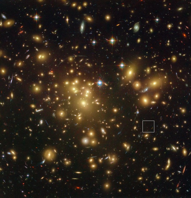 This spectacular view from the NASA/ESA Hubble Space Telescope shows the rich galaxy cluster Abell 1689. The huge concentration of mass bends light coming from more distant objects and can increase their total apparent brightness and make them visible. One such object, A1689-zD1, is located in the box — although it is still so faint that it is barely seen in this picture. Credit: NASA; ESA; L. Bradley (Johns Hopkins University); R. Bouwens (University of California, Santa Cruz); H. Ford (Johns Hopkins University); and G. Illingworth (University of California, Santa Cruz) This spectacular view from the NASA/ESA Hubble Space Telescope shows the rich galaxy cluster Abell 1689. The huge concentration of mass bends light coming from more distant objects and can increase their total apparent brightness and make them visible. One such object, A1689-zD1, is located in the box — although it is still so faint that it is barely seen in this picture. Credit: NASA; ESA; L. Bradley (Johns Hopkins University); R. Bouwens (University of California, Santa Cruz); H. Ford (Johns Hopkins University); and G. Illingworth (University of California, Santa Cruz)