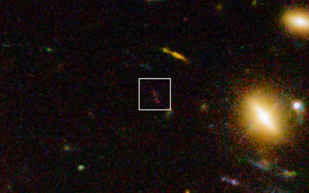 This view includes infrared light images from the WFC3 instrument on the NASA/ESA Hubble Space Telescope as well as visible light views. It shows a close up look at part of the rich galaxy cluster Abell 1689. The huge concentration of mass bends light coming from more distant objects and can increase their total apparent brightness and make them visible. One such object, A1689-zD1, appears on this picture as the elongated reddish object in the box. Credit: ESO/J. Richard This view includes infrared light images from the WFC3 instrument on the NASA/ESA Hubble Space Telescope as well as visible light views. It shows a close up look at part of the rich galaxy cluster Abell 1689. The huge concentration of mass bends light coming from more distant objects and can increase their total apparent brightness and make them visible. One such object, A1689-zD1, appears on this picture as the elongated reddish object in the box. Credit: ESO/J. Richard