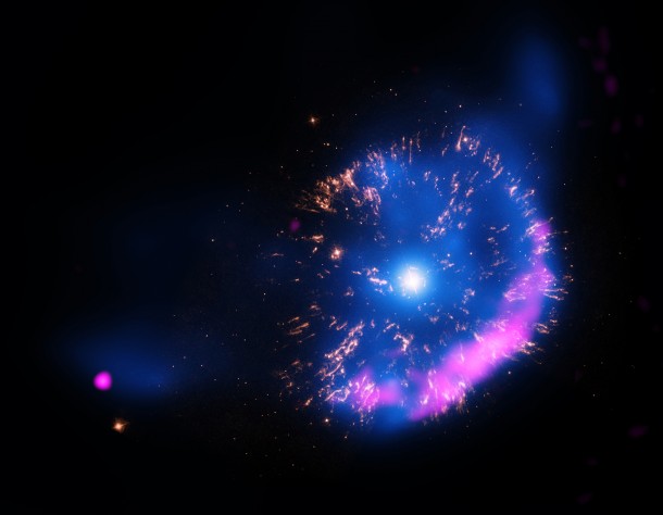This new image of GK Persei contains X-rays from Chandra (blue), optical data from NASA’s Hubble Space Telescope (yellow), and radio data from the National Science Foundation’s Very Large Array (pink). Image Credit: NASA/CXC/RIKEN/D.Takei et al This new image of GK Persei contains X-rays from Chandra (blue), optical data from NASA’s Hubble Space Telescope (yellow), and radio data from the National Science Foundation’s Very Large Array (pink). Image Credit: NASA/CXC/RIKEN/D.Takei et al