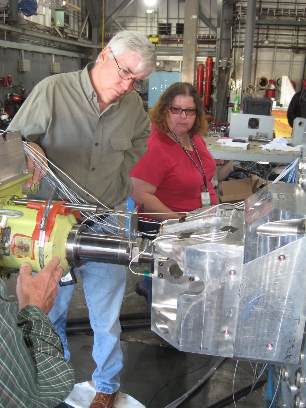 NASA Marshall's Roger Parisa and Miranda Holton get the thrust vector control actuator ready for vibration testing. Image Credit: NASA/MSFC NASA Marshall's Roger Parisa and Miranda Holton get the thrust vector control actuator ready for vibration testing. Image Credit: NASA/MSFC