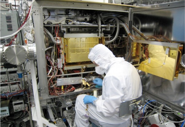 A Sample Analysis at Mars (SAM) team member at NASA Goddard prepares the SAM testbed for an experiment. This test copy of the SAM suite of instruments is inside a chamber that, when closed, can model the pressure and temperature environment that SAM sees inside Curiosity on Mars. Image Credit: NASA A Sample Analysis at Mars (SAM) team member at NASA Goddard prepares the SAM testbed for an experiment. This test copy of the SAM suite of instruments is inside a chamber that, when closed, can model the pressure and temperature environment that SAM sees inside Curiosity on Mars. Image Credit: NASA