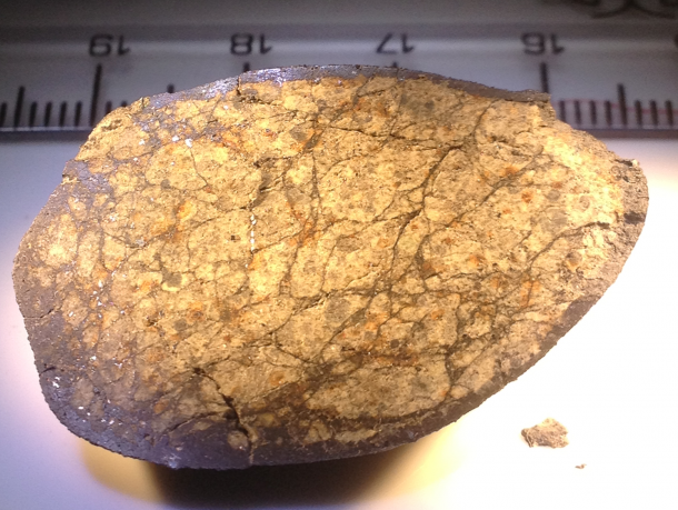 Chelyabinsk meteorite. This specimen shows a highly developed network of thin impact melt veins (dark lines) and impact melt pockets (dark areas). The dark material around the outside of the meteorite is not impact melt, but fusion crust created during atmospheric entry; the presence of fusion crust indicates this stone broke away from the main mass during entry. Shiny metallic grains are readily visible Image Credit: Qingzhu Yin, Univ. California-Davis Chelyabinsk meteorite. This specimen shows a highly developed network of thin impact melt veins (dark lines) and impact melt pockets (dark areas). The dark material around the outside of the meteorite is not impact melt, but fusion crust created during atmospheric entry; the presence of fusion crust indicates this stone broke away from the main mass during entry. Shiny metallic grains are readily visible Image Credit: Qingzhu Yin, Univ. California-Davis