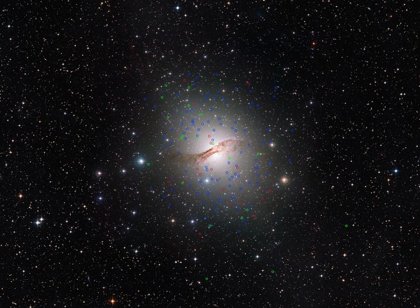 This huge elliptical galaxy NGC 5128 (also known as Centaurus A) is the closest such galaxy to the Earth, at a distance of about 12 million light-years. Observations with ESO’s Very Large Telescope in Chile have discovered a new class of “dark” globular star clusters around this galaxy. These are marked in red. Normal globulars are marked in blue and globulars showing similar properties to dwarf galaxies are in green. The dark globulars appear very similar to other globulars around this galaxy but contain much more mass. Credit: ESO/Digitized Sky Survey. Acknowledgement: Davide de Martin This huge elliptical galaxy NGC 5128 (also known as Centaurus A) is the closest such galaxy to the Earth, at a distance of about 12 million light-years. Observations with ESO’s Very Large Telescope in Chile have discovered a new class of “dark” globular star clusters around this galaxy. These are marked in red. Normal globulars are marked in blue and globulars showing similar properties to dwarf galaxies are in green. The dark globulars appear very similar to other globulars around this galaxy but contain much more mass. Credit: ESO/Digitized Sky Survey. Acknowledgement: Davide de Martin