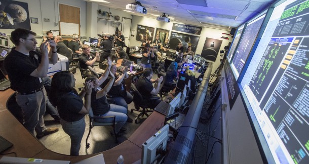 New Horizons Flight Controllers celebrate after they received confirmation from the spacecraft that it had successfully completed the flyby of Pluto, Tuesday, July 14, 2015 in the Mission Operations Center (MOC) of the Johns Hopkins University Applied Physics Laboratory (APL), Laurel, Maryland. Credits: NASA/Bill Ingalls New Horizons Flight Controllers celebrate after they received confirmation from the spacecraft that it had successfully completed the flyby of Pluto, Tuesday, July 14, 2015 in the Mission Operations Center (MOC) of the Johns Hopkins University Applied Physics Laboratory (APL), Laurel, Maryland. Credits: NASA/Bill Ingalls