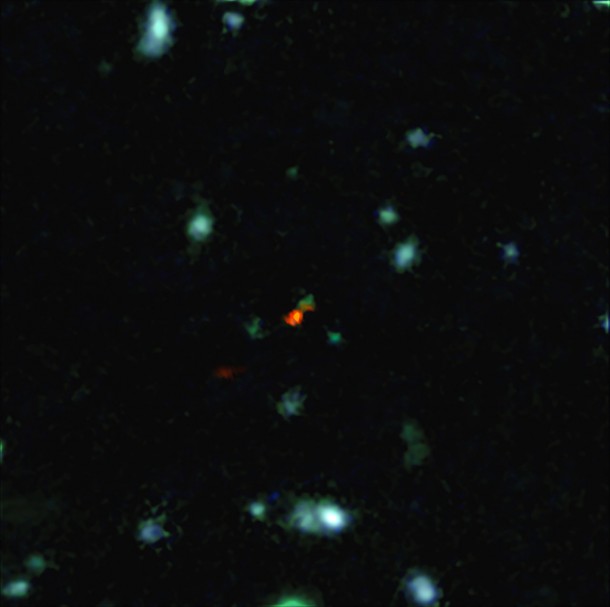 This view is a combination of images from ALMA and the Very Large Telescope. The central object is a very distant galaxy, labelled BDF 3299, which is seen when the Universe was less than 800 million years old. The bright red cloud just to the lower left is the ALMA detection of a vast cloud of material that is in the process of assembling the very young galaxy. Credit: ESO/R. Maiolino This view is a combination of images from ALMA and the Very Large Telescope. The central object is a very distant galaxy, labelled BDF 3299, which is seen when the Universe was less than 800 million years old. The bright red cloud just to the lower left is the ALMA detection of a vast cloud of material that is in the process of assembling the very young galaxy. Credit: ESO/R. Maiolino