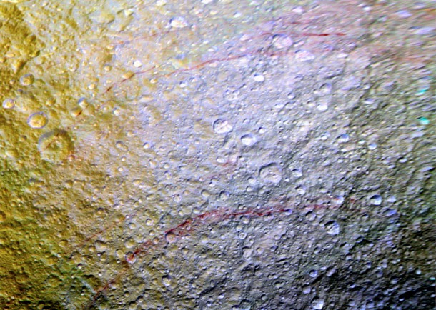 Unusual arc-shaped, reddish streaks cut across the surface of Saturn's ice-rich moon Tethys in this enhanced-color mosaic. The red streaks are narrow, curved lines on the moon's surface, only a few miles (or kilometers) wide but several hundred miles (or kilometers) long. The red streaks are among the most unusual color features on Saturn's moons to be revealed by Cassini's cameras. Credits: NASA/JPL-Caltech/Space Science Institute Unusual arc-shaped, reddish streaks cut across the surface of Saturn's ice-rich moon Tethys in this enhanced-color mosaic. The red streaks are narrow, curved lines on the moon's surface, only a few miles (or kilometers) wide but several hundred miles (or kilometers) long. The red streaks are among the most unusual color features on Saturn's moons to be revealed by Cassini's cameras. Credits: NASA/JPL-Caltech/Space Science Institute