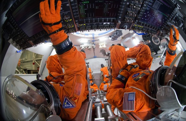 Spacesuit engineers demonstrate how four crew members would be arranged for launch inside the Orion spacecraft, using a mockup of the vehicle at Johnson Space Center. Credits: NASA/Robert Markowitz Spacesuit engineers demonstrate how four crew members would be arranged for launch inside the Orion spacecraft, using a mockup of the vehicle at Johnson Space Center. Credits: NASA/Robert Markowitz