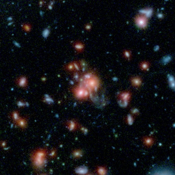 A massive cluster of galaxies, called SpARCS1049+56, can be seen in this multi-wavelength view from NASA's Hubble and Spitzer space telescopes. Image credit: NASA/STScI/ESA/JPL-Caltech/McGill A massive cluster of galaxies, called SpARCS1049+56, can be seen in this multi-wavelength view from NASA's Hubble and Spitzer space telescopes. Image credit: NASA/STScI/ESA/JPL-Caltech/McGill