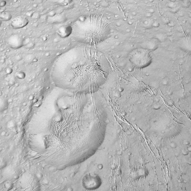 NASA's Cassini spacecraft spied this tight trio of craters as it approached Saturn's icy moon Enceladus for a close flyby on Oct. 14, 2015. The craters, located at high northern latitudes, are sliced through by thin fractures -- part of a network of similar cracks that wrap around the snow-white moon. Image Credit: NASA/JPL-Caltech/Space Science Institute NASA's Cassini spacecraft spied this tight trio of craters as it approached Saturn's icy moon Enceladus for a close flyby on Oct. 14, 2015. The craters, located at high northern latitudes, are sliced through by thin fractures -- part of a network of similar cracks that wrap around the snow-white moon. Image Credit: NASA/JPL-Caltech/Space Science Institute