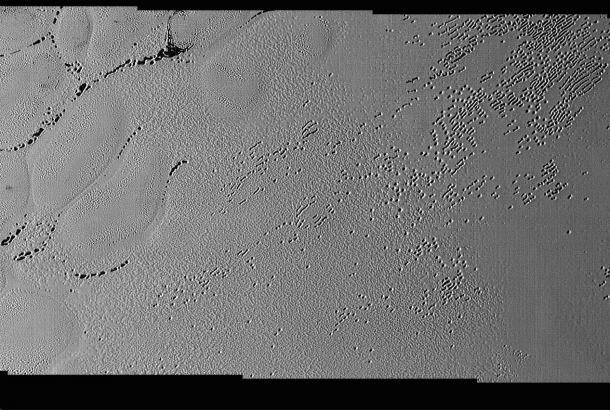 This image was taken by the Long Range Reconnaissance Imager (LORRI) on NASA's New Horizons spacecraft shortly before closest approach to Pluto on July 14, 2015; it resolves details as small as 270 yards (250 meters). The scene shown is about 130 miles (210 kilometers) across. The sun illuminates the scene from the left, and north is to the upper left. Credits: NASA/JHUAPL/SwRI This image was taken by the Long Range Reconnaissance Imager (LORRI) on NASA's New Horizons spacecraft shortly before closest approach to Pluto on July 14, 2015; it resolves details as small as 270 yards (250 meters). The scene shown is about 130 miles (210 kilometers) across. The sun illuminates the scene from the left, and north is to the upper left. Credits: NASA/JHUAPL/SwRI