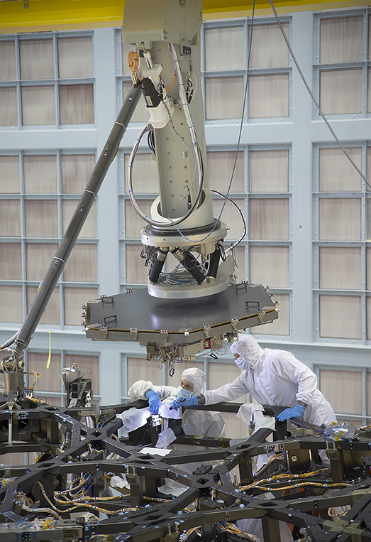 Inside a massive clean room at NASA's Goddard Space Flight Center in Greenbelt, Maryland the James Webb Space Telescope Team prepared for the first flight mirror's installation onto the telescope structure. Credits: NASA/Chris Gunn Inside a massive clean room at NASA's Goddard Space Flight Center in Greenbelt, Maryland the James Webb Space Telescope Team prepared for the first flight mirror's installation onto the telescope structure. Credits: NASA/Chris Gunn