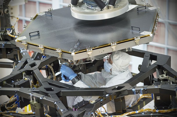 An engineer at NASA's Goddard Space Flight Center worked to install the first flight mirror onto the telescope structure at NASA's Goddard Space Flight Center in Greenbelt, Maryland. Credits: NASA/Chris Gunn An engineer at NASA's Goddard Space Flight Center worked to install the first flight mirror onto the telescope structure at NASA's Goddard Space Flight Center in Greenbelt, Maryland. Credits: NASA/Chris Gunn