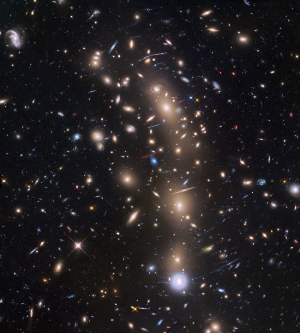This is a Hubble Space Telescope view of a very massive cluster of galaxies, MACS J0416.1-2403, located roughly 4 billion light-years away and weighing as much as a million billion suns. Image credit: NASA, ESA, and Pontificia Universidad Católica de Chile This is a Hubble Space Telescope view of a very massive cluster of galaxies, MACS J0416.1-2403, located roughly 4 billion light-years away and weighing as much as a million billion suns. Image credit: NASA, ESA, and Pontificia Universidad Católica de Chile
