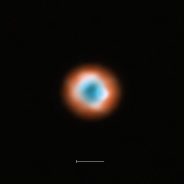 This ALMA image combines a view of the dust around the young star DoAr 44 (orange) with a view of the gaseous material (blue). The smaller hole in the inner gas is a telltale sign of the presence of a young planet clearing the disc. The bar at the bottom of the image indicates the diameter of the orbit of Neptune in the Solar System (60 AU). Credit: ALMA (ESO/NOAJ/NRAO) This ALMA image combines a view of the dust around the young star DoAr 44 (orange) with a view of the gaseous material (blue). The smaller hole in the inner gas is a telltale sign of the presence of a young planet clearing the disc. The bar at the bottom of the image indicates the diameter of the orbit of Neptune in the Solar System (60 AU). Credit: ALMA (ESO/NOAJ/NRAO)