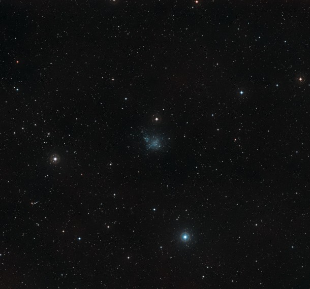 This wide-field view shows the sky around the dwarf galaxy IC 1613 in the constellation of Cetus (The Sea Monster). This picture was created from images forming part of the Digitized Sky Survey 2. The galaxy appears at the centre of the picture as an irregularly shaped clump of faint stars. Credit: ESO/Digitized Sky Survey 2. Acknowledgement: Davide De Martin This wide-field view shows the sky around the dwarf galaxy IC 1613 in the constellation of Cetus (The Sea Monster). This picture was created from images forming part of the Digitized Sky Survey 2. The galaxy appears at the centre of the picture as an irregularly shaped clump of faint stars. Credit: ESO/Digitized Sky Survey 2. Acknowledgement: Davide De Martin