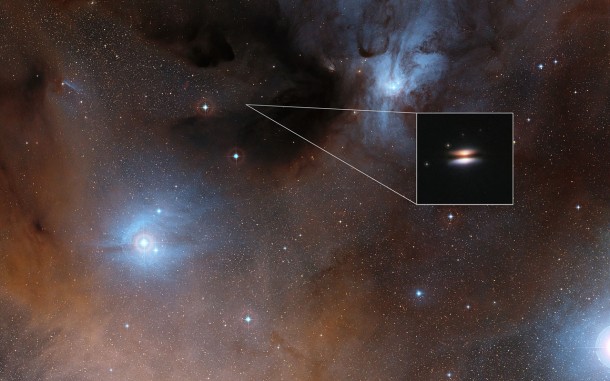 The main image shows part of the Rho Ophiuchi region and a much enlarged close-up infrared view of the Flying Saucer from the NASA/ESA Hubble Space Telescope is shown as an insert. Credit: Digitized Sky Survey 2/NASA/ESA The main image shows part of the Rho Ophiuchi region and a much enlarged close-up infrared view of the Flying Saucer from the NASA/ESA Hubble Space Telescope is shown as an insert. Credit: Digitized Sky Survey 2/NASA/ESA