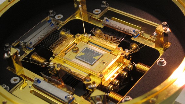 The heart of the ASTRO-H Soft X-ray Spectrometer is the microcalorimeter array at center. The five-millimeter square forms a 36-pixel array. Each pixel is 0.824 millimeter on a side, or about the width of the ball in a ballpoint pen. The detector's field of view is approximately three arcminutes, or one-tenth the apparent diameter of the full moon. Credits: NASA's Goddard Space Flight Center The heart of the ASTRO-H Soft X-ray Spectrometer is the microcalorimeter array at center. The five-millimeter square forms a 36-pixel array. Each pixel is 0.824 millimeter on a side, or about the width of the ball in a ballpoint pen. The detector's field of view is approximately three arcminutes, or one-tenth the apparent diameter of the full moon. Credits: NASA's Goddard Space Flight Center