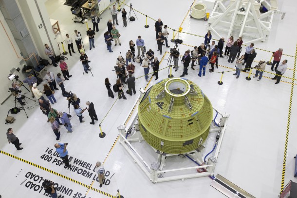 Inside the Neil Armstrong Operations and Checkout Building high bay at NASA's Kennedy Space Center in Florida, members of the news media get an up-close look at the Orion crew module pressure vessel on Feb. 3. Testing and assembly has begun, which will lead to Exploration Mission-1 in 2018. EM-1 will be an uncrewed flight test in which the spacecraft will launch atop NASA’s Space Launch System rocket. Photo credit: NASA/Bill White Inside the Neil Armstrong Operations and Checkout Building high bay at NASA's Kennedy Space Center in Florida, members of the news media get an up-close look at the Orion crew module pressure vessel on Feb. 3. Testing and assembly has begun, which will lead to Exploration Mission-1 in 2018. EM-1 will be an uncrewed flight test in which the spacecraft will launch atop NASA’s Space Launch System rocket. Photo credit: NASA/Bill White