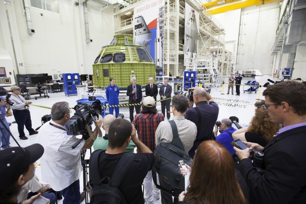 Inside the Neil Armstrong Operations and Checkout Building high bay at NASA's Kennedy Space Center in Florida, Scott Wilson, manager of Orion Production Operations at Kennedy, speaks to members of the news media. To his right is NASA astronaut Stan Love. To his left are Mark Geyer, deputy director of NASA's Johnson Space Center in Houston, and Mike Hawes, Lockheed Martin's Orion Program manager. Photo credit: NASA/Bill White Inside the Neil Armstrong Operations and Checkout Building high bay at NASA's Kennedy Space Center in Florida, Scott Wilson, manager of Orion Production Operations at Kennedy, speaks to members of the news media. To his right is NASA astronaut Stan Love. To his left are Mark Geyer, deputy director of NASA's Johnson Space Center in Houston, and Mike Hawes, Lockheed Martin's Orion Program manager. Photo credit: NASA/Bill White