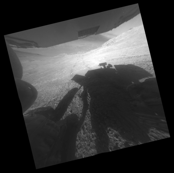A shadow and tracks of NASA's Mars rover Opportunity appear in this March 22, 2016, image, which has been rotated 13.5 degrees to adjust for the tilt of the rover. Image Credit: NASA/JPL-Caltech A shadow and tracks of NASA's Mars rover Opportunity appear in this March 22, 2016, image, which has been rotated 13.5 degrees to adjust for the tilt of the rover. Image Credit: NASA/JPL-Caltech